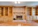Inviting living room with brick fireplace, custom built-in shelving, and hardwood floors at 5124 Vermack Rd, Dunwoody, GA 30338