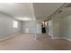 Unfinished basement with carpet flooring, painted walls, and access to the stairs and utility area at 802 San Miguel Dr, Stone Mountain, GA 30083