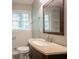 Bathroom featuring granite counters, updated fixtures, a mirror and a window at 802 San Miguel Dr, Stone Mountain, GA 30083