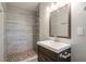 Bathroom featuring a modern vanity, new tiled shower, and neutral decor at 802 San Miguel Dr, Stone Mountain, GA 30083