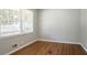 Light-filled bedroom featuring hardwood floors, fresh paint and a large window at 802 San Miguel Dr, Stone Mountain, GA 30083