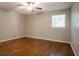 Bedroom featuring hardwood floors, one window and neutral-colored walls at 802 San Miguel Dr, Stone Mountain, GA 30083