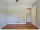 Bedroom with hardwood floors, neutral walls, and an open closet at 802 San Miguel Dr, Stone Mountain, GA 30083