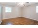 Bright bedroom featuring hardwood floors, neutral walls, and natural light from two windows at 802 San Miguel Dr, Stone Mountain, GA 30083