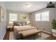 Staged bedroom features natural light, wood floors, art and neutral decor at 802 San Miguel Dr, Stone Mountain, GA 30083