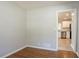 This empty room features beautiful hard wood floors and a doorway that leads to the kitchen at 802 San Miguel Dr, Stone Mountain, GA 30083