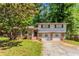 Split-level home featuring a brick and siding facade, front porch, and a two-car garage at 802 San Miguel Dr, Stone Mountain, GA 30083