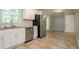 Clean kitchen with white cabinets, stainless steel appliances, tile backsplash, and tile flooring at 802 San Miguel Dr, Stone Mountain, GA 30083