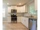 Charming kitchen featuring white cabinets, stainless steel appliances, and granite countertops at 802 San Miguel Dr, Stone Mountain, GA 30083