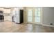 Bright kitchen features white cabinets, stainless steel appliances, and access to the outdoors through glass doors at 802 San Miguel Dr, Stone Mountain, GA 30083