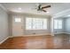 Living room featuring hardwood floors, crown molding, ceiling fan, and many windows at 802 San Miguel Dr, Stone Mountain, GA 30083