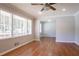 A spacious living room featuring hardwood floors, many windows, and neutral paint at 802 San Miguel Dr, Stone Mountain, GA 30083