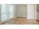 Sun-filled room with French doors that lead to a landing, plus access to stairs to another level at 802 San Miguel Dr, Stone Mountain, GA 30083