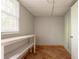 Bright storage room featuring tile flooring, a window, and shelving at 802 San Miguel Dr, Stone Mountain, GA 30083