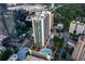 Aerial view showcasing the high-rise building, surrounding cityscape, and rooftop pool at 3324 Peachtree Ne Rd # 1304, Atlanta, GA 30326