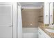 Bathroom features a shower-tub with tan tiles and granite countertop sink with white cabinets at 3324 Peachtree Ne Rd # 1304, Atlanta, GA 30326