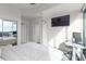 Modern bedroom with large tv, desk and floor-to-ceiling windows showcasing stunning views at 3324 Peachtree Ne Rd # 1304, Atlanta, GA 30326