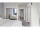 Light filled bedroom with a mirrored closet leading to the ensuite bathroom and commode at 3324 Peachtree Ne Rd # 1304, Atlanta, GA 30326