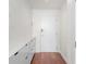 Clean, modern entryway featuring hardwood floors, white walls, and convenient built-in storage cabinets at 3324 Peachtree Ne Rd # 1304, Atlanta, GA 30326