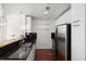 Modern kitchen with stainless appliances, black backsplash, and granite countertops at 3324 Peachtree Ne Rd # 1304, Atlanta, GA 30326