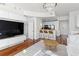 Open-concept living area with kitchen and breakfast bar featuring hardwood floors and modern lighting at 3324 Peachtree Ne Rd # 1304, Atlanta, GA 30326