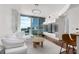 Bright living room with modern lighting, balcony, and floor-to-ceiling windows boasting city views at 3324 Peachtree Ne Rd # 1304, Atlanta, GA 30326