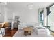 Bright living room featuring a large sectional sofa, city views, and modern lighting at 3324 Peachtree Ne Rd # 1304, Atlanta, GA 30326