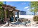 Charming outdoor patio with comfortable seating, a stone fire pit, and serene city views beyond the trees at 3324 Peachtree Ne Rd # 1304, Atlanta, GA 30326