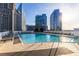 Inviting rooftop pool with clear blue water, surrounded by lounge chairs and impressive cityscape views at 3324 Peachtree Ne Rd # 1304, Atlanta, GA 30326