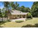 Charming brick home featuring a cozy patio and a spacious, well-manicured backyard, perfect for outdoor enjoyment at 4981 Forestglade Ct, Stone Mountain, GA 30087