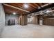 Unfinished basement with exposed beams and block walls, providing a blank canvas for customization and storage at 4981 Forestglade Ct, Stone Mountain, GA 30087