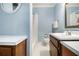 Bathroom featuring toilet, vanity, shower, and white tile at 4981 Forestglade Ct, Stone Mountain, GA 30087