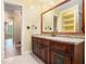 Bathroom featuring a vanity with granite countertop, mirror, and adjacent room at 4981 Forestglade Ct, Stone Mountain, GA 30087