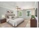 Bedroom featuring a bed, two windows, ceiling fan, and two nightstands at 4981 Forestglade Ct, Stone Mountain, GA 30087