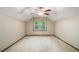 Empty bedroom with a ceiling fan and a window providing natural light at 4981 Forestglade Ct, Stone Mountain, GA 30087