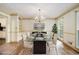 Dining room with a modern glass table set for a dinner party at 4981 Forestglade Ct, Stone Mountain, GA 30087