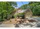 Well-maintained two-story brick home with an attached garage and mature trees, nestled on a landscaped lot at 4981 Forestglade Ct, Stone Mountain, GA 30087