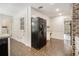 Bright eat-in kitchen features brick floors, white cabinetry, and modern refrigerator at 4981 Forestglade Ct, Stone Mountain, GA 30087