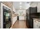 Bright kitchen with white cabinets, a tiled floor, and black appliances at 4981 Forestglade Ct, Stone Mountain, GA 30087