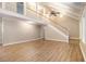 Bright living room with hardwood floors, staircase, and high ceilings, creating an open and airy space at 4981 Forestglade Ct, Stone Mountain, GA 30087