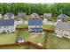 Aerial view of a home showcasing a spacious, fenced backyard with a screened porch at 548 Azalea Bloom Drive E, Loganville, GA 30052
