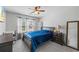 Bright bedroom with natural light, a ceiling fan, and a functional desk area at 548 Azalea Bloom Drive E, Loganville, GA 30052