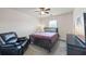 Cozy bedroom with a comfortable bed, recliner, and natural light at 548 Azalea Bloom Drive E, Loganville, GA 30052
