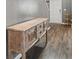 Foyer with wood-look flooring and decorative wooden console table at 548 Azalea Bloom Drive E, Loganville, GA 30052