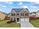 Beautiful two-story brick home featuring a two-car garage, manicured lawn, and inviting curb appeal at 548 Azalea Bloom Drive E, Loganville, GA 30052
