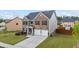 Charming two-story residence with a two-car garage, well-kept lawn, and attractive brick facade at 548 Azalea Bloom Drive E, Loganville, GA 30052