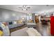 Bright living room with hardwood floors, sectional sofa, and open kitchen view at 548 Azalea Bloom Drive E, Loganville, GA 30052
