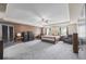 Spacious main bedroom with wood accent wall and plush carpeting at 548 Azalea Bloom Drive E, Loganville, GA 30052