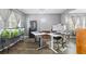 Spacious home office with large windows, hardwood floors, and an aquarium at 548 Azalea Bloom Drive E, Loganville, GA 30052