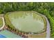 A well-maintained pond with a walking trail creates a beautiful and tranquil community setting at 548 Azalea Bloom Drive E, Loganville, GA 30052